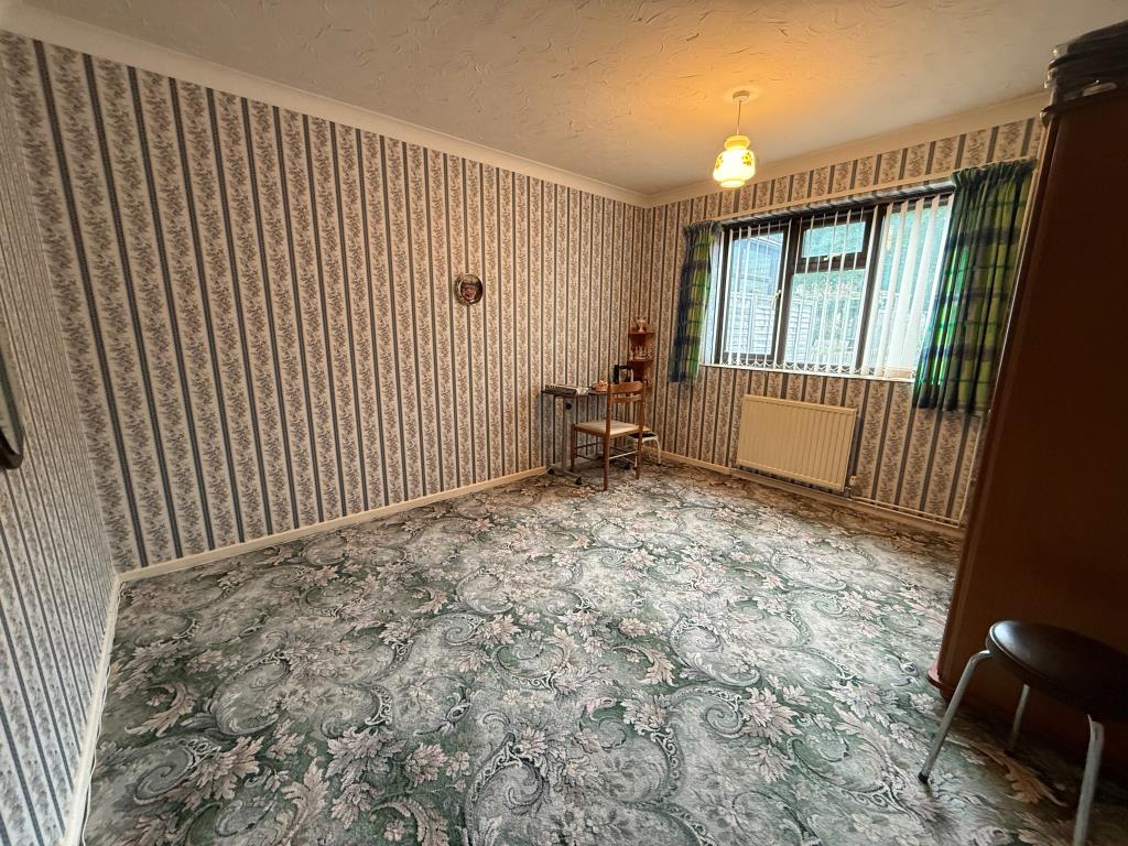 Lot: 102 - TWO-BEDROOM BUNGALOW IN NEED OF IMPROVEMENT - Carpeted bedroom with window and wardrobe